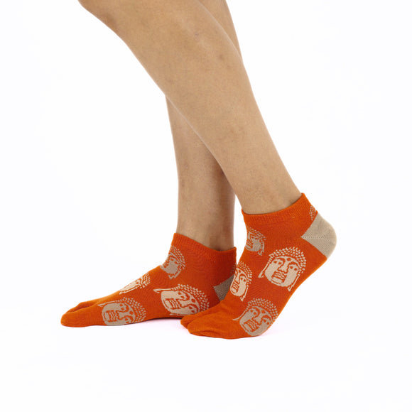Person wearing short orange Tabi Socks " Nara Daibutsu ", right side view