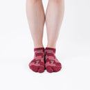 Person wearing short dark red Tabi Socks " Shika Nozoku ", front view