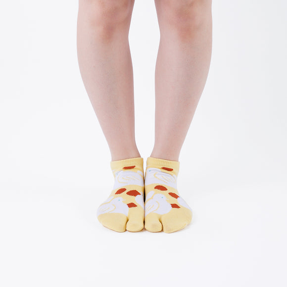 Person wearing short yellow Tabi Socks " Hato ", front view