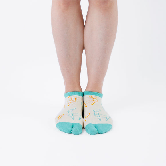 Person wearing short light yellow Tabi Socks " Shika Origami ", front view