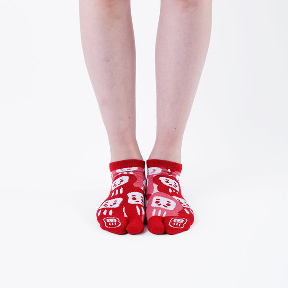 Person wearing short red Tabi Socks " Daruma ", front view