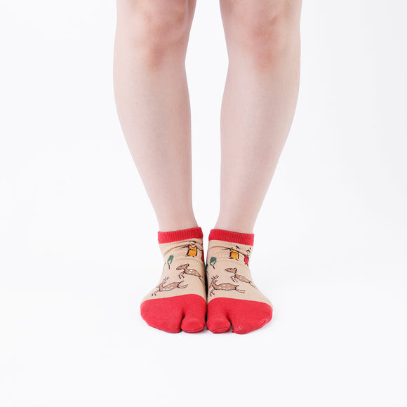Person wearing short red Tabi Socks " Nara-e ", front view