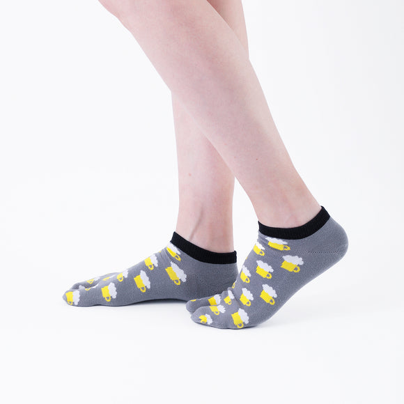 Person wearing short gray Tabi Socks " Beer ", right side view