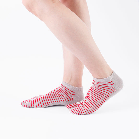 Person wearing short red Tabi Socks " Hyoshigi ", right side view