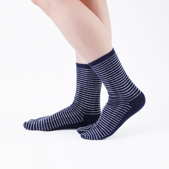Person wearing long navy Tabi Socks " Hyoshigi ", right side view