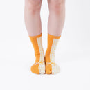 Person wearing long yellow Tabi Socks " Goen ", front view