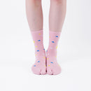 Person wearing long pink Tabi Socks " Surfer ", front view