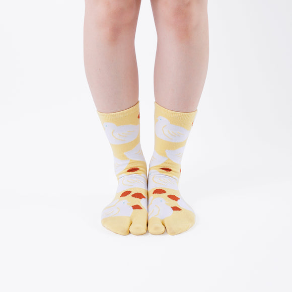 Person wearing long yellow Tabi Socks " Hato ", front view