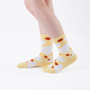 Person wearing long yellow Tabi Socks " Hato ", right side view