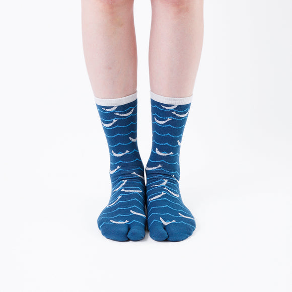 Person wearing long blue Tabi Socks " Shirasu ", front view