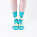 Person wearing long green Tabi Socks " Densha ", front view
