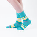 Person wearing long green Tabi Socks " Densha ", right side view
