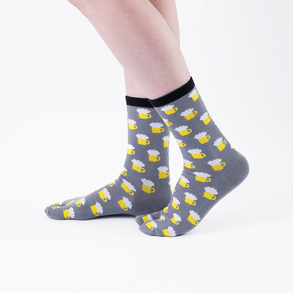 Person wearing long gray Tabi Socks " Beer ", right side view