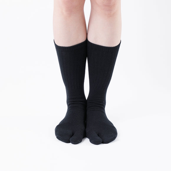 Person wearing black Tabi Socks "NOBI NOBI", front view